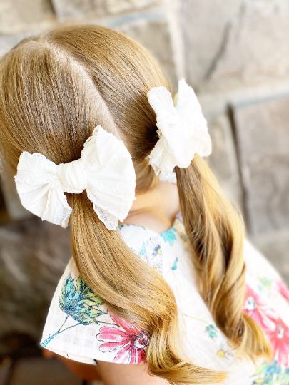 Girl Wearing 2 White Ruffle Frilly Bows - Golden Dot Lane