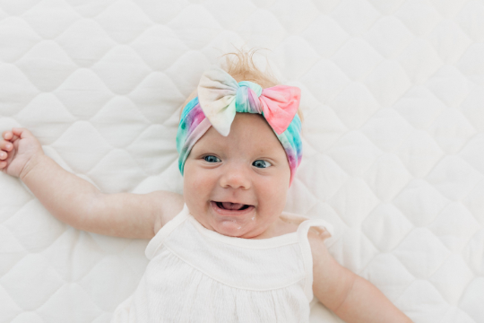 Baby Girl Wearing Watercolor Tie Dye Nylon Headband - Golden Dot Lane