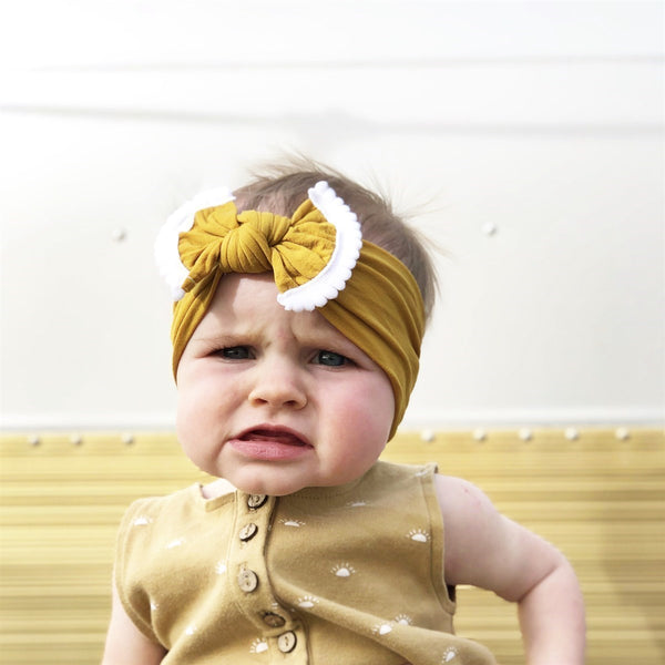 Baby Wearing Mustard Pom Pom Nylon Headband - Golden Dot Lane